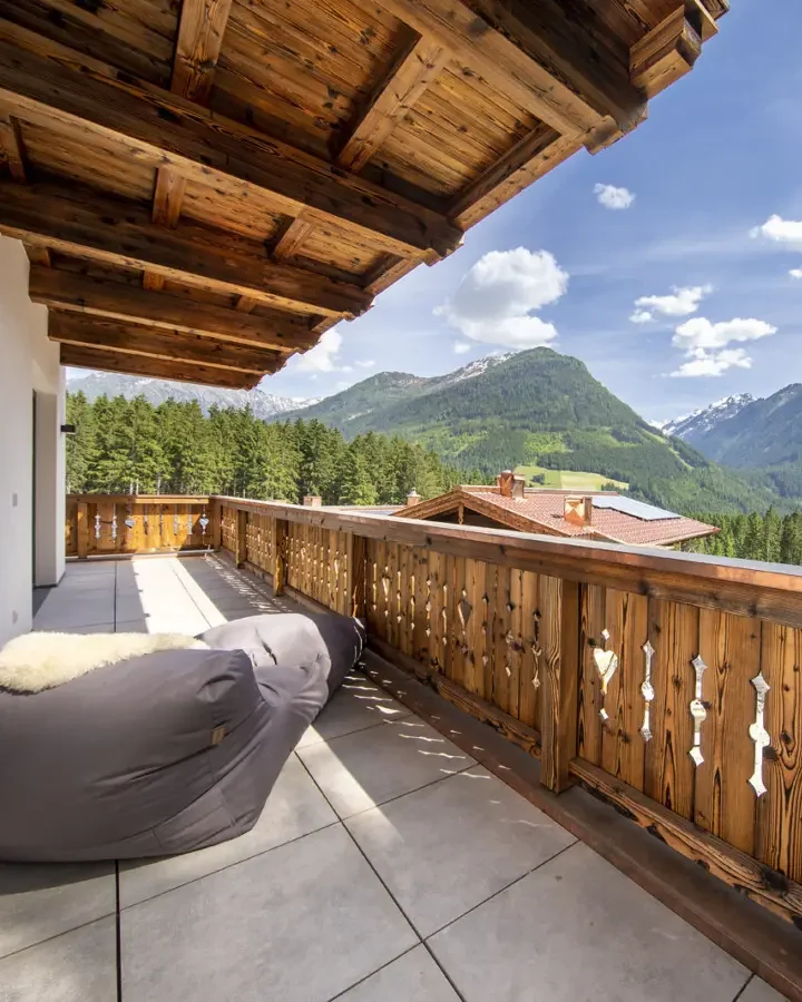 Sitzsack auf dem Balkon, dahinter Wald und Berge